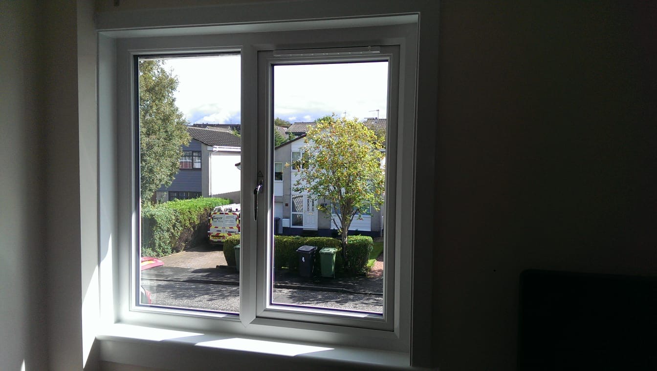 Double white uPVC casement window with bright garden view