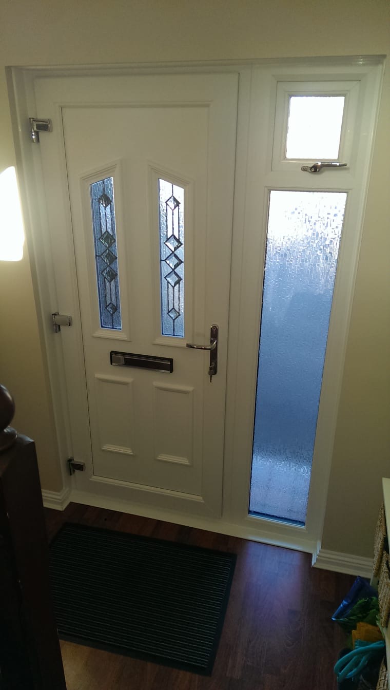 White uPVC front door with lead diamond glazing and frosted side panel, interior view